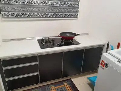 a frying pan on a stove in a kitchen at HOMESTAY EPOH Meru Raya in Ipoh