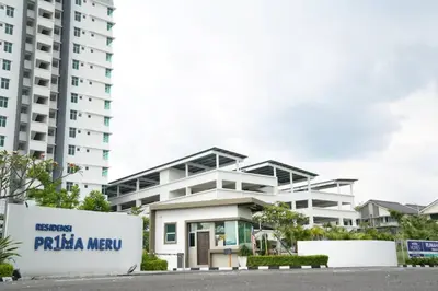 a white apartment building with a sign in front of it at HOMESTAY EPOH Meru Raya in Ipoh