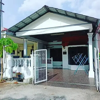a white garage with a gate in front of a house at Homestay Musafir 3.0 in Seri Iskandar