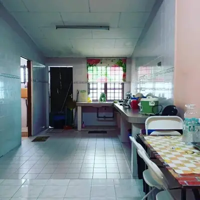 a kitchen with a table and a counter top at Homestay Musafir 3.0 in Seri Iskandar