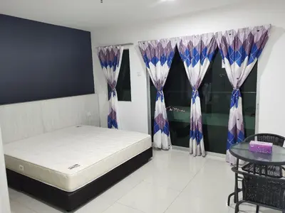 a bedroom with a bed and a table and curtains at Marina Couple Home Stay, No Counter reception, please look details in Lumut