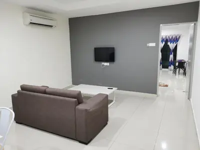 a living room with a couch and a tv on a wall at Marina Couple Home Stay, No Counter reception, please look details in Lumut