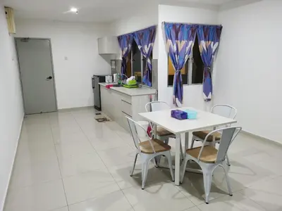 a kitchen with a table and chairs in a room at Marina Couple Home Stay, No Counter reception, please look details in Lumut