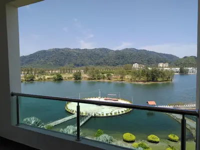a view of a lake from a balcony at Marina Couple Home Stay, No Counter reception, please look details in Lumut