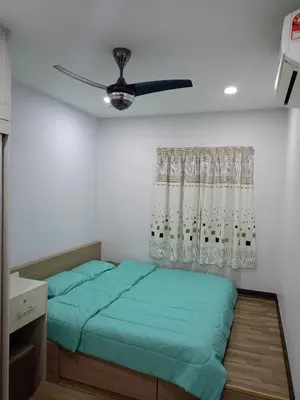 a bedroom with two beds and a ceiling fan at Best Sekinchan homestay in Sekincan