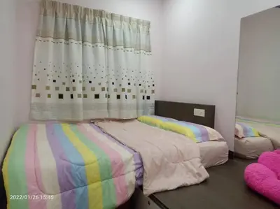 a bedroom with two beds and a window at Best Sekinchan homestay in Sekincan