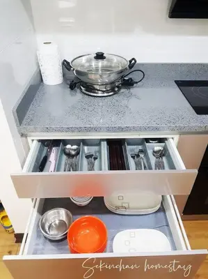 a drawer in a kitchen with a pot on top at Best Sekinchan homestay in Sekincan