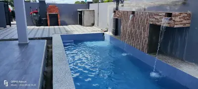 a pool of water outside a building with a water fall at Rania Homestay With Private Pool Seri Iskandar Perak Near UTP UITM in Kampong Bota Road