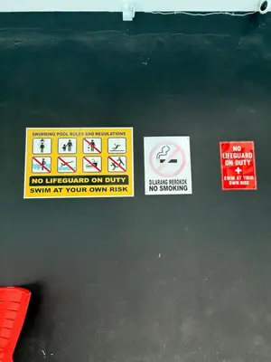 a group of signs on a black table at KH Water Park Manhattan Condo Ipoh Homestay in Kampong Pinji