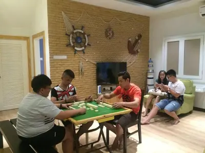 a group of people sitting around a table playing chess at Pearl Rice Garden \uff08cottage style\uff09\u7c73\u6a02\u574a\u9802\u5c64\u7530\u56ed\u5f0f\u9ad8\u7ea7\u516c\u5bd3 in Sekincan