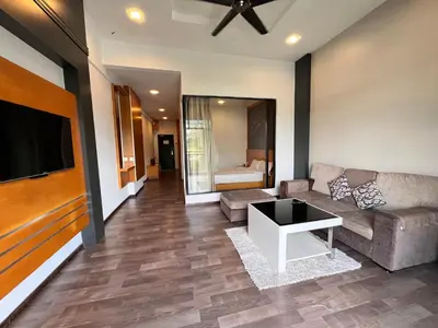 a living room with a couch and a tv at Hotel Studio Apartment- Fantastic Mountain View (4pax) in Brinchang