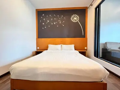 a bedroom with a large bed and a window at Hotel Studio Apartment- Fantastic Mountain View (4pax) in Brinchang