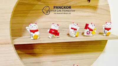 a group of cat figurines sitting on a shelf at Pangkor Better Life Minimalist Beach Villa-13 to15pax Free WiFi in Pangkor
