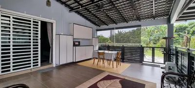a kitchen with a table and chairs and large windows at Tambun Hillview Cottage 1 in Tambun