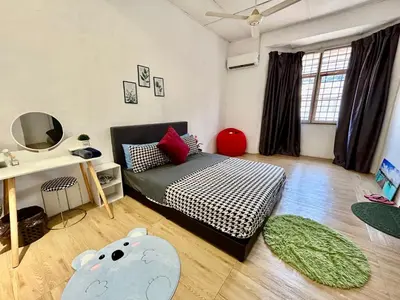 a bedroom with a bed and a room with a elephant pillow at Cozy 10 Entire House 4 Bedroom At Alma Bukit Mertajam in Bukit Mertajam