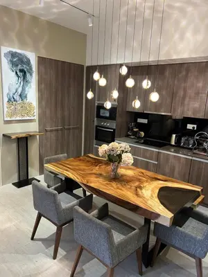 a dining room with a wooden table and chairs at By The Sea Beachfront Designer Suites Penang - Managed by Art of Tree in Batu Ferringhi