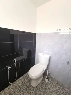 a bathroom with a toilet and a shower in it at Wellson Home Ipoh 58 10px \u5168\u65b0\u94fe\u63a5\u5f0f\u6c11\u5bbf\u6709\u4e24\u95f4 in Ipoh