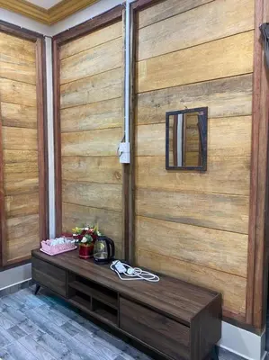 a wooden wall with a bench in front of it at HOMESTAY DUSUN ANA BALUN in Slim River