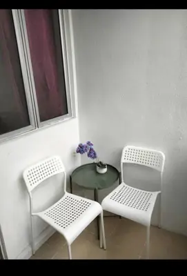 two white chairs and a table and a window at Muslim Boutique Apartment with Balcony in Tanah Rata