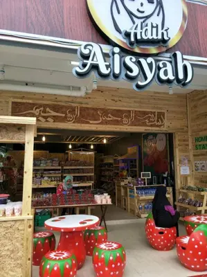 a store with red and green chairs and a sign at Muslim Boutique Apartment with Balcony in Tanah Rata