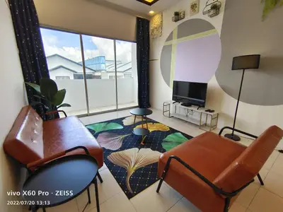 a living room with a couch and a tv at ifloral CH1 in Tanah Rata