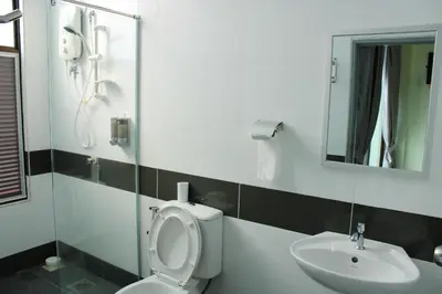 a bathroom with a toilet and a sink and a mirror at Happy Valley Eco Farm in Kerling