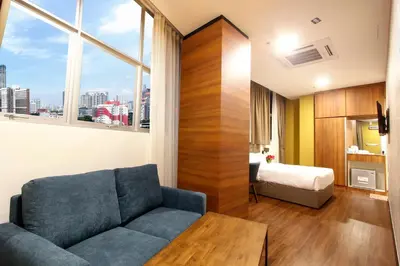 a living room with a couch and a bed at CitiVilla Hotel Penang in George Town