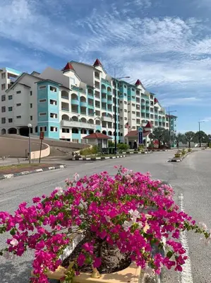 a bouquet of pink flowers in front of a building at Glossy Marina Homestays in Lumut