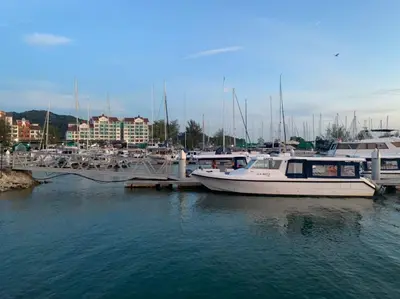 a group of boats docked at a marina at Glossy Marina Homestays in Lumut