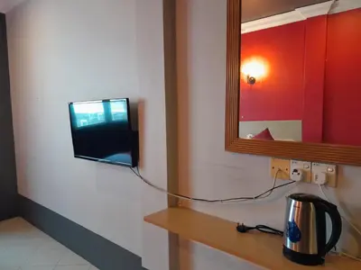 a television on a wall in a room at V HOTEL in Teluk Intan