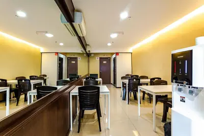 a restaurant with tables and chairs and a bar at PP Hotel Penang in George Town