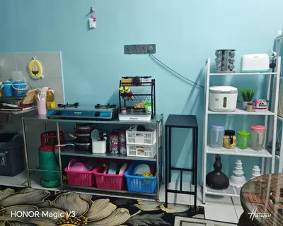 a room with a shelf with items on it at Mieda Rizqi Homestay in Kampong Melayu Changkat Larah