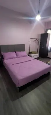 a purple bed in a room with a purple bedspread at Cosy Homestay Tanah Rata in Tanah Rata