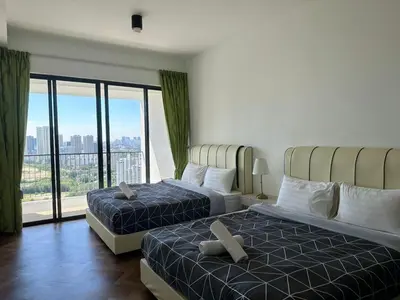 a hotel room with two beds and a large window at LM HomeyA 3 BdRm Coastline View condo for 4-14 Pax with Netflix & Coway Water Purifier in Tanjong Tokong