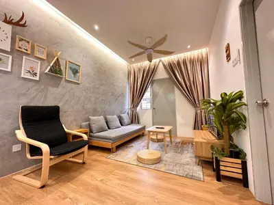 a living room with a couch and a chair at [Muji-Style Apartment] @ Cameron Jaya (3R2B) 8 pax in Tanah Rata