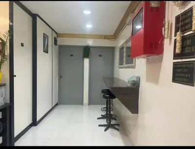 a corridor of a restaurant with a bar in a room at ESM Hotel in Tanah Rata