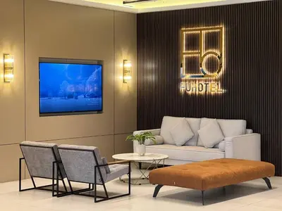 a living room with a couch and a table at FUHOTEL in Bukit Mertajam