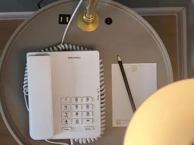 a white calculator sitting on top of a table at FUHOTEL in Bukit Mertajam