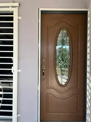 a brown door with a window on a house at Homestay Salak 756 at Sungai Siput Kuala Kangsar for Islamic Guest Only in Sungai Siput