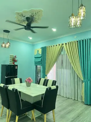 a dining room with a table and chairs at Homestay Salak 756 at Sungai Siput Kuala Kangsar for Islamic Guest Only in Sungai Siput
