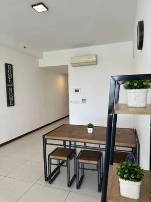 a table and two stools in a room at The Landmark Comfort Relax Spacious Sea View By IZ in Tanjong Tokong