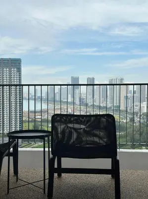 a bench on a balcony with a view of a city at The Landmark Comfort Relax Spacious Sea View By IZ in Tanjong Tokong