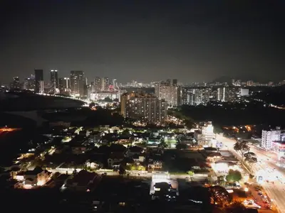 a city lit up at night with buildings at The Landmark Comfort Relax Spacious Sea View By IZ in Tanjong Tokong