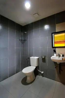 a bathroom with a toilet and a sink at Golden Roof Hotel Falim Ipoh in Ipoh