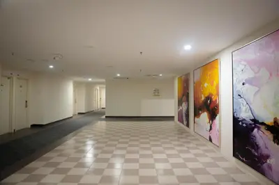 an empty hallway with paintings on the walls at Golden Roof Hotel Ampang Ipoh in Ipoh