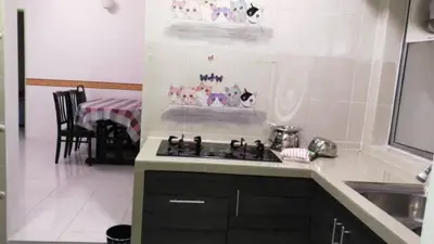 a kitchen with a sink and a stove top oven at SA @ Cameron Emerald Avenue in Brinchang