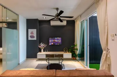 a living room with a ceiling fan and a table at 2R1B/Seaview Garden/1~8pax/Gurney/Mansion One in George Town