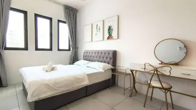 a bedroom with a bed and a mirror and a desk at De Luma - Meritus in Perai