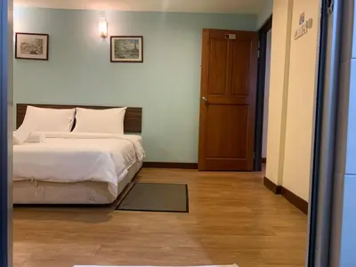 a bedroom with a bed and a wooden door at D'Feringghi Hotel in Batu Ferringhi