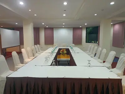 a large conference room with a long table and white chairs at D'Feringghi Hotel in Batu Ferringhi
